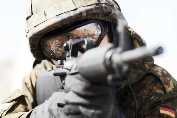 Serving his country. Close up of a german soldier pointing his gun ready to fire.