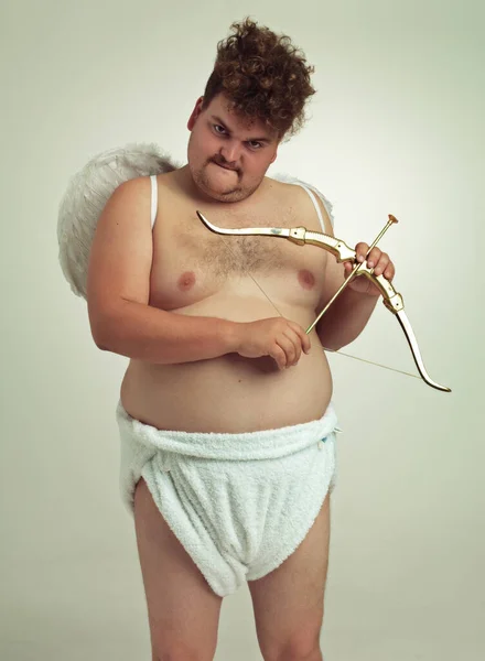 Machen Sie sich bereit, sich zu verlieben. Ein fettleibiger Mann als Cherub mit Pfeil und Bogen. — Stockfoto