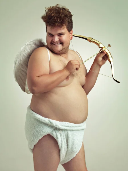 他带来了爱这个情人节。一个肥胖的男人，穿着像个拿着弓箭的小天使. — 图库照片