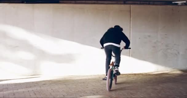 梦想大和踏板的辛苦。4k视频，一个年轻的bmx自行车手在桥下玩把戏. — 图库视频影像