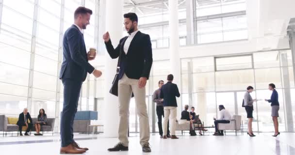Vengan juntos y triunfen en los negocios. Imágenes de video de 4k de jóvenes empresarios guapos dándose un puñetazo en el centro de convenciones. — Vídeos de Stock