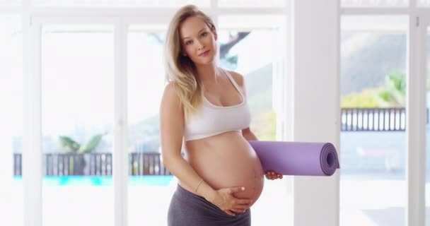 Exercice pendant la grossesse fait des merveilles. Vidéo 4K d'une femme enceinte tenant son tapis de yoga. — Video