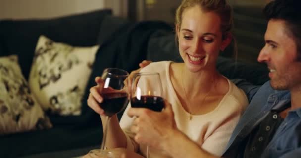 Heres to many more romantic moments. 4K video footage of a happy young couple enjoying a glass of wine during a romantic night at home. — Stock Video