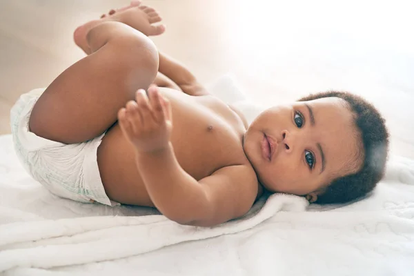 Can someone change my diaper please. Shot of an adorable baby girl at home. — Stock Photo, Image