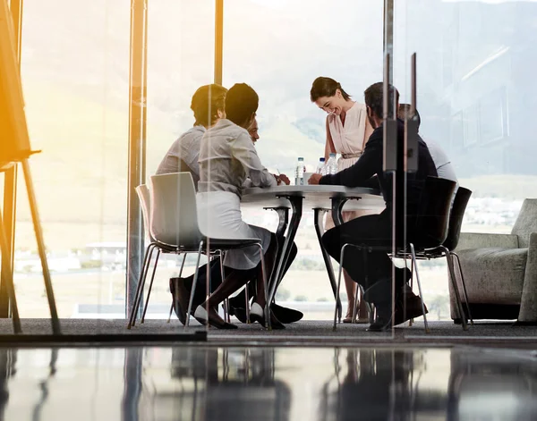 Feeling positive about todays meeting. Shot of a businesswoman giving a presentation to a group of colleagues in a boardroom.