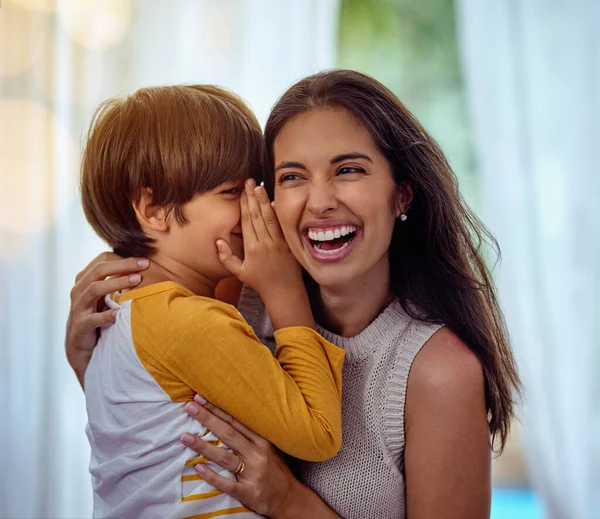 Hey mom guess what I love you. Shot of an adorable little boy whispering into his mothers ear. — Stock Photo, Image