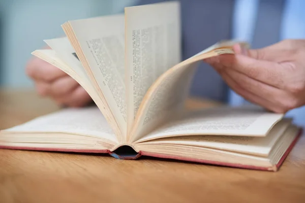 Make your success story a page turner. Cropped shot of an unidentifiable man reading a book. — Stock Photo, Image