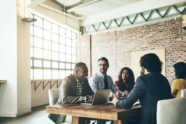 Vale la pena escuchar cada idea. Fotografía de un grupo diverso de empresarios teniendo una reunión alrededor de una mesa en su oficina. —  Fotos de Stock