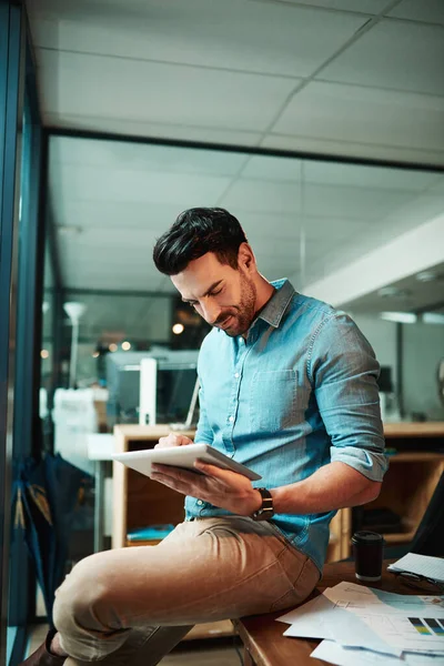 Zakelijk, hij doet het digitaal. Foto van een jonge zakenman met een digitale tablet in een modern kantoor. — Stockfoto