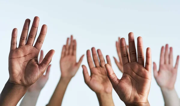 Raise your hands as one. Shot of a group of hands reaching up against a white background. — Stock Photo, Image