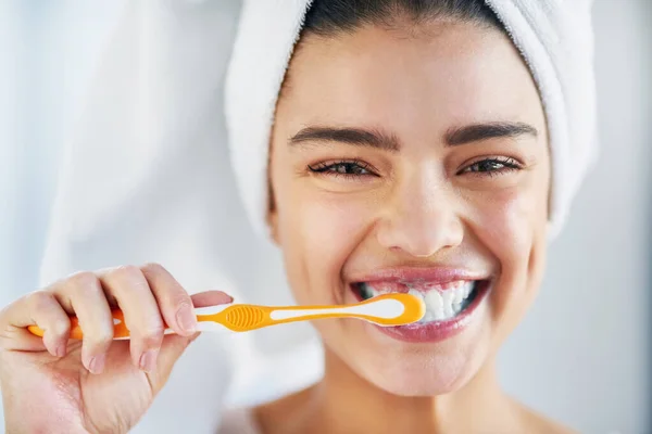 É o hábito que não podes deixar passar. Retrato de uma bela jovem escovando os dentes no banheiro em casa. — Fotografia de Stock