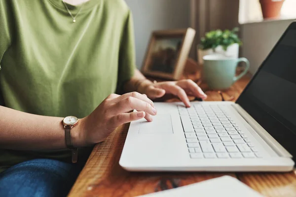 An entrepreneurs job is never over. Cropped shot of an unrecognizable businesswoman sitting alone in her home office and typing on her laptop. — Stock Photo, Image