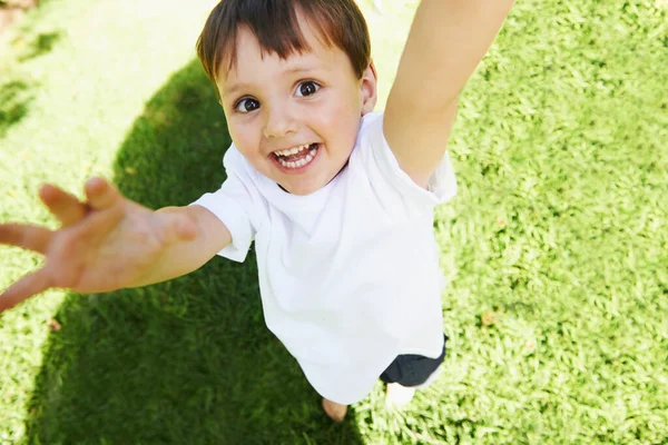 Yay Its time to play. High angle view of a little boy reaching up into the air. — Stock Photo, Image