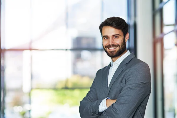Self confidence is key to a successful career. Portrait of a confident young businessman standing in a modern office. — Stock Photo, Image