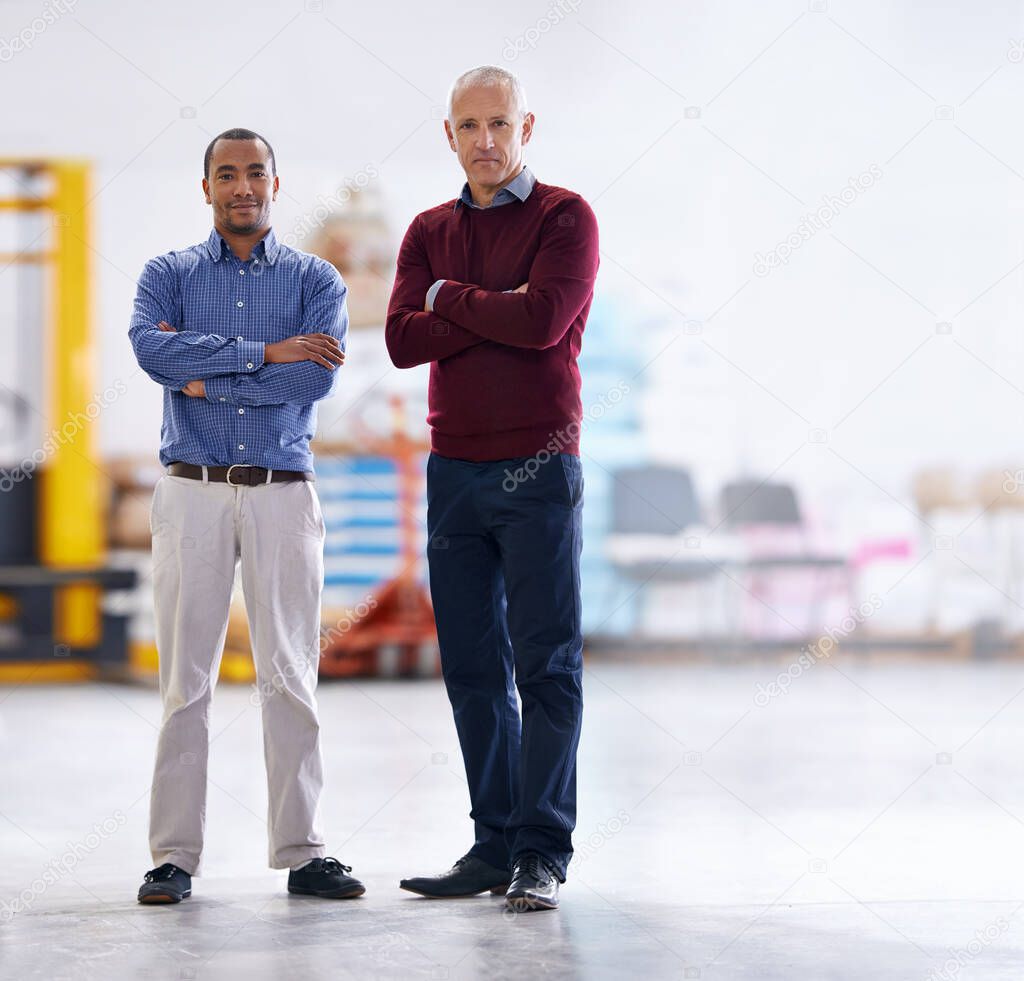 Meet the inspectors. Portrait of two factory managers doing a warehouse inspection.