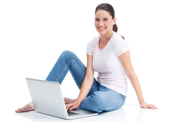 Sharing her thoughts with the world. Happy young woman sitting on the floor with her laptop. Royalty Free Stock Images