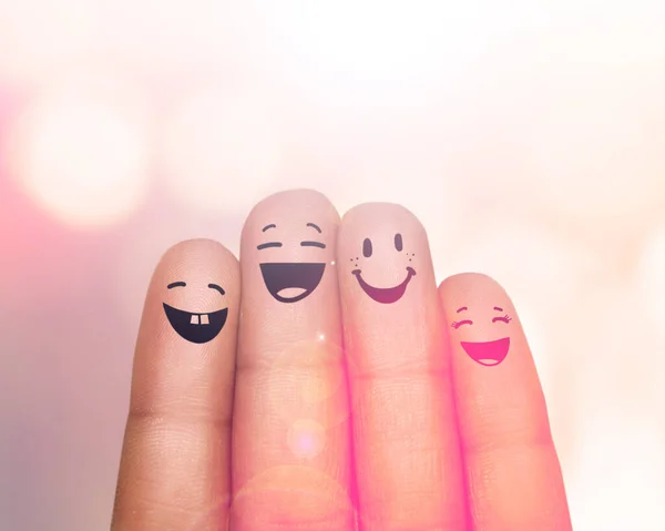 Were a happy family of fingers. Cropped shot of fingers with smileys drawn on them.