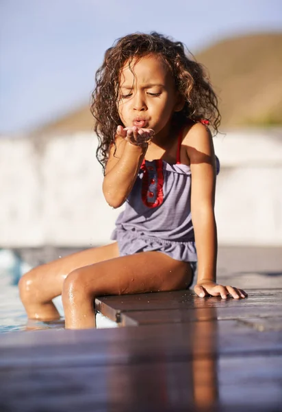 Water fun. Shot of a little girl playing by the pool. — Stock Photo, Image