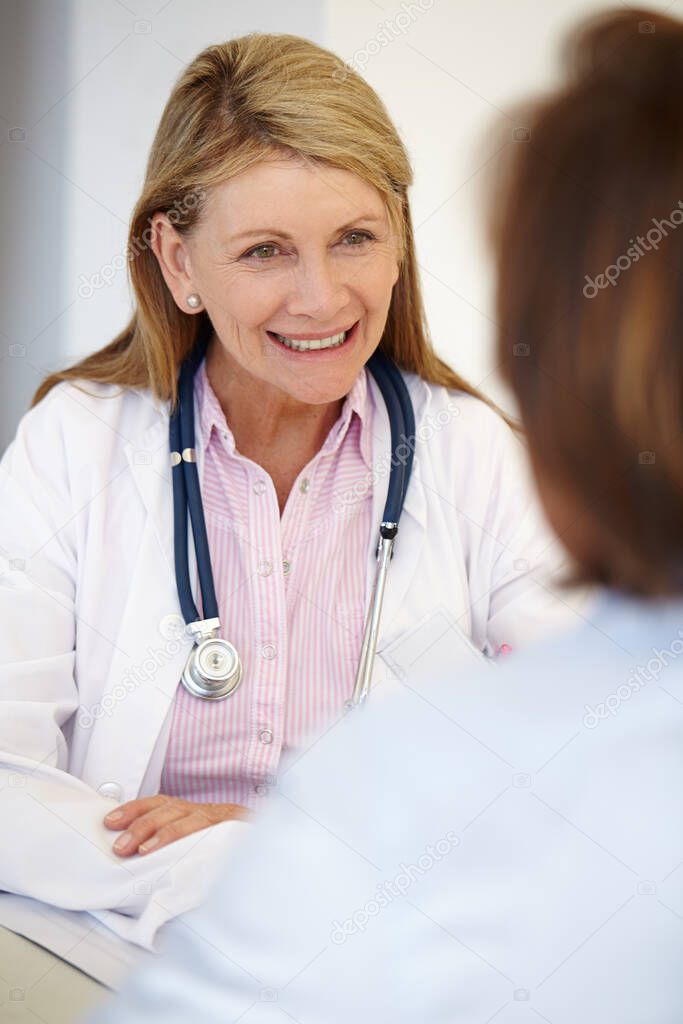 Help is just a warm smile away. Portrait of a mature female doctor having a conversation.