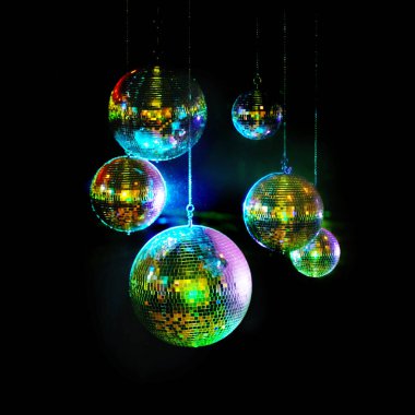 Mirror balls above dance floors. Awesome image of kaleidoscopic-looking disco balls hanging against a black background. clipart