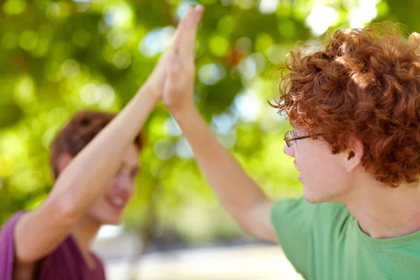 Were awesome. Cropped shot of two teenagers giving each other a high-five. — Stock Photo, Image