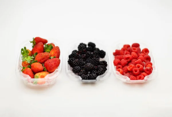 Natures Bonbon. Studioaufnahme von Erdbeeren, Himbeeren und Brombeeren in separaten Behältern.. — Stockfoto