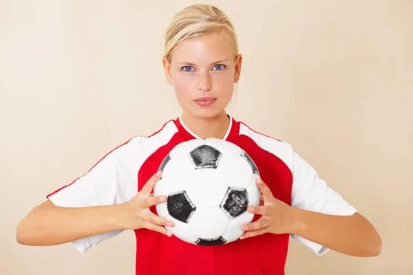 Moja pasja. Portret atrakcyjnej młodej kobiety trzymającej piłkę nożną. — Zdjęcie stockowe
