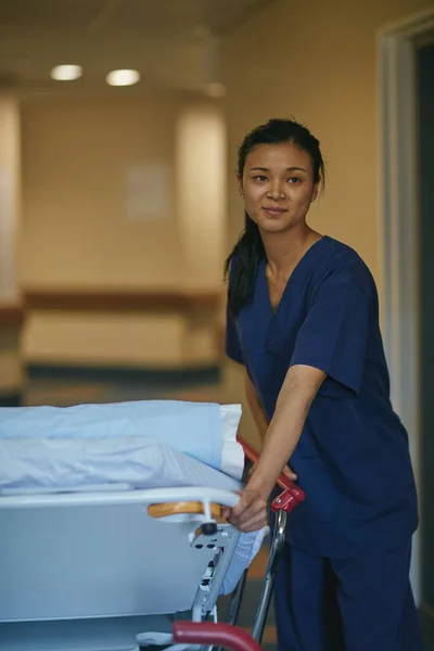 Maak het bed klaar voor de volgende patiënt. Gehakt schot van een vrouwelijke verpleegster naast een ziekenhuisbed. — Stockfoto
