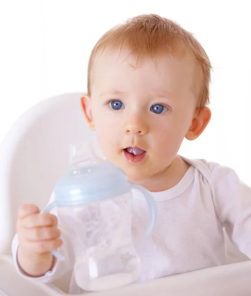 He knows when he wants some more. An adorable baby boy holding up his baby bottle to be filled. Royalty Free Stock Photos