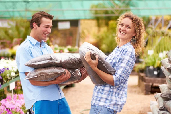 Ready to do some gardening. A couple buying fertilizer in a local nursery. — Stock Photo, Image