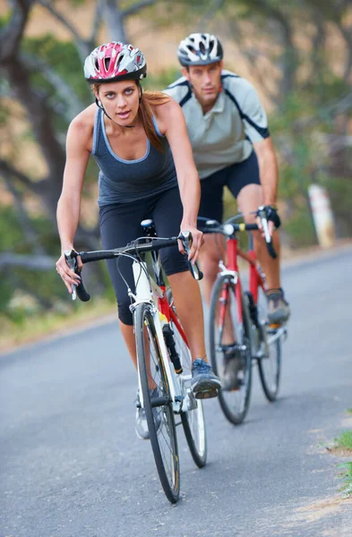 Dit stel houdt van competitie. Foto van een koppel dat samen op hun fietstocht was gericht. — Stockfoto