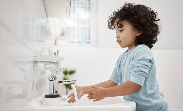 Kinder müssen ihre Hände sauber halten. Aufnahme eines entzückenden kleinen Jungen, der sich im heimischen Badezimmer an einem Wasserhahn die Hände wäscht. — Stockfoto