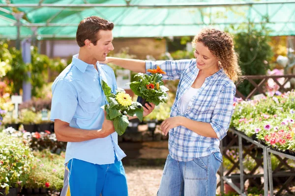 What about these. Cropped shot of a young couple picking out flowers in a boutique. — Stock Photo, Image