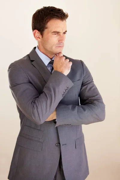 Thinking about corporate strategy. A handsome young businessman looking thoughtful. — Stock Photo, Image