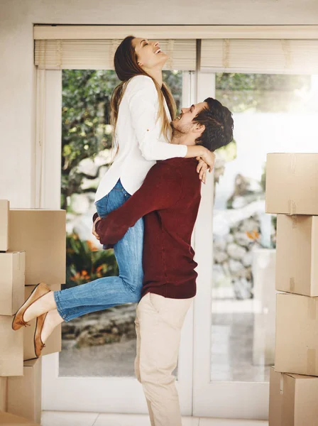 Their new home will be full of love. Cropped shot of an affectionate young couple embracing while moving into a new home. — Stock Photo, Image