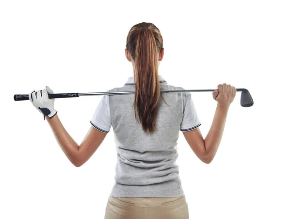 In command of her club. Studio shot of a young golfer holding a golf club behind her back isolated on white. — Stock Photo, Image