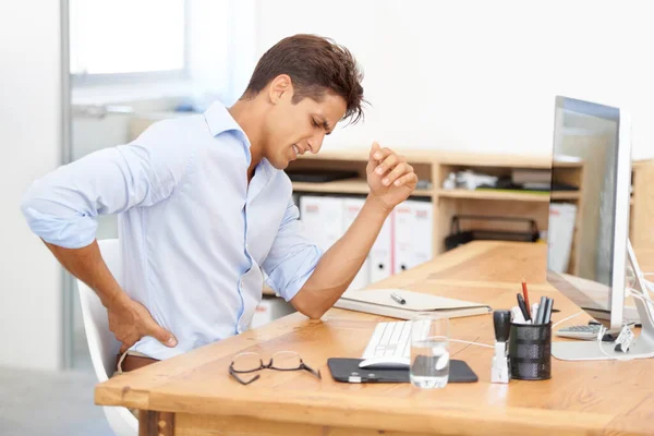 Acıya göğüs germek... Sırtı ağrıyan genç bir ofis çalışanının masasında oturması.. — Stok fotoğraf