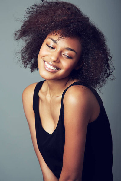 Her personality shines through. A smiling young woman with an afro.