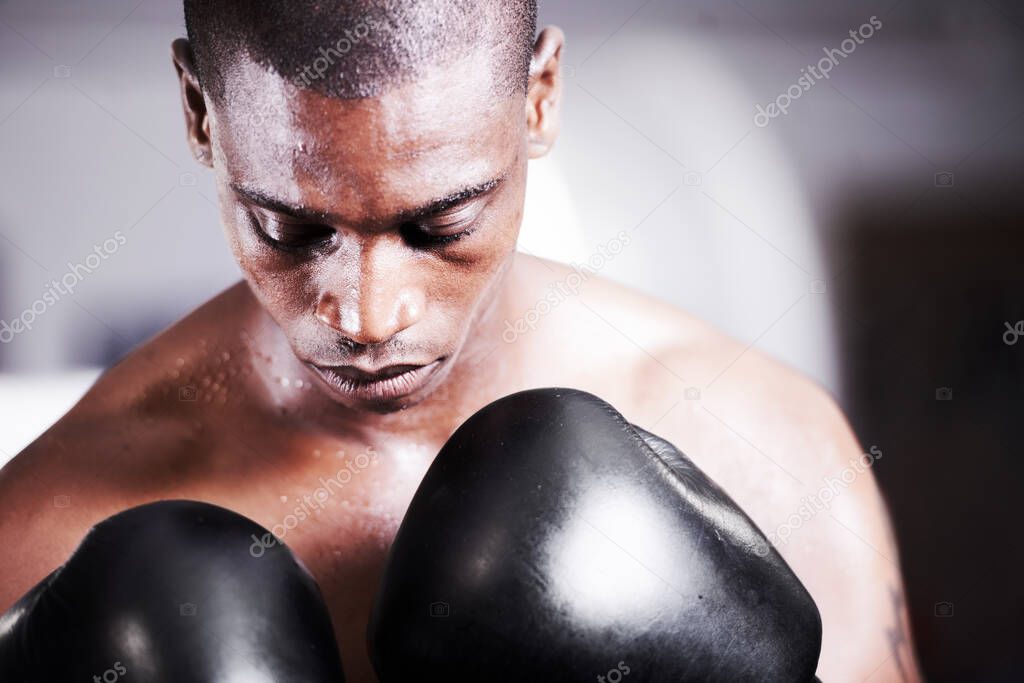Visualizing success. A young boxer taking some time to visualize before a fight.