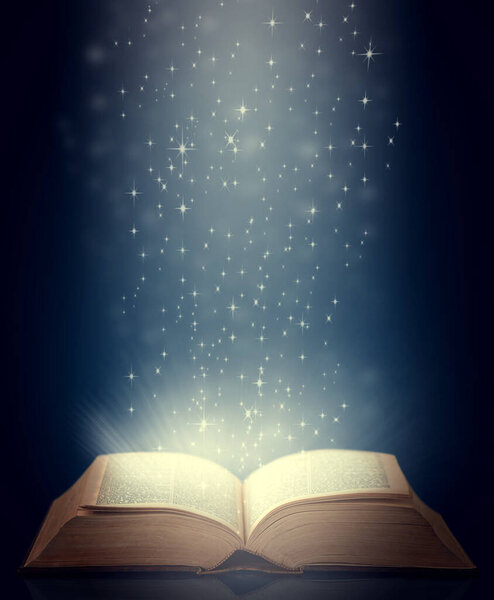 Shot of an open storybook with light emanating from it.