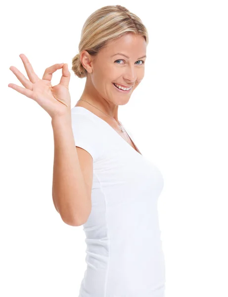 Your message is just perfect. Studio shot of an attractive woman giving you a hand signal for perfect against a white background. — Stock Photo, Image