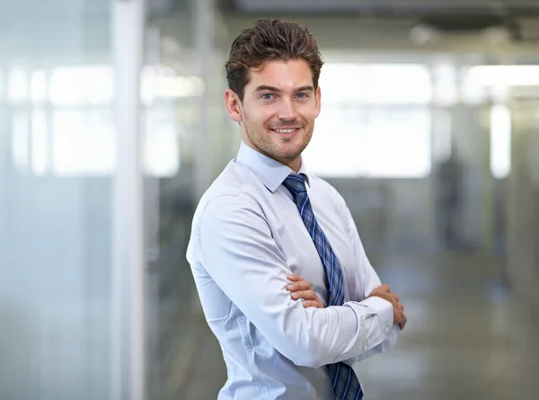 Hes a mover and shaker. Shot of a young businessman in a corporate office. — Stock Photo, Image