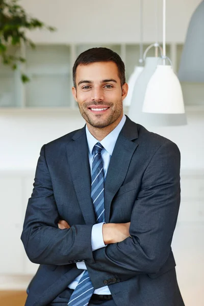 At home in the corporate workplace. Handsome young businessman looking confident with his arms folded. — Stock Photo, Image