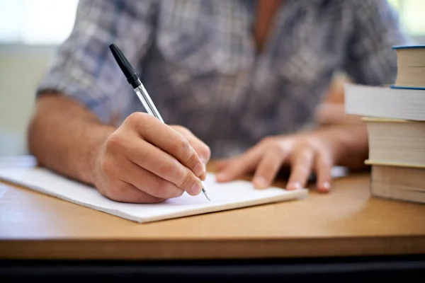 Üniversite kendini adamayı gerektirir. Çalışırken not alan genç bir adamın kırpılmış fotoğrafı.. — Stok fotoğraf
