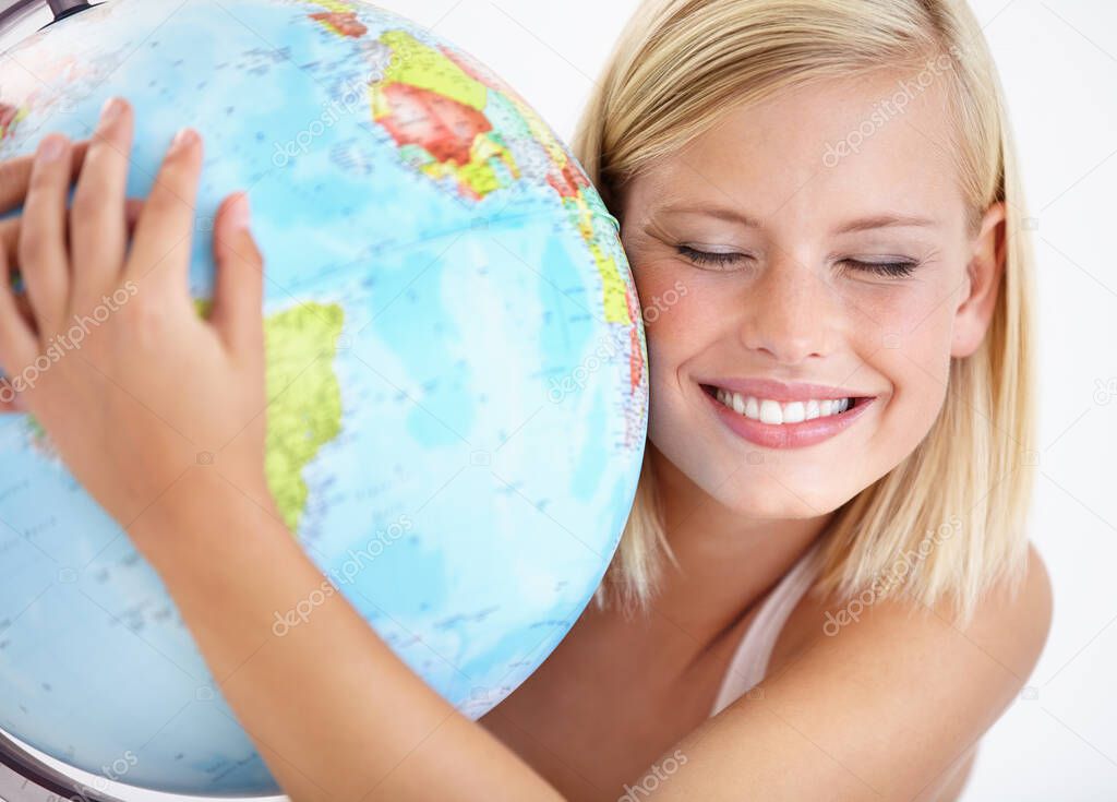 Our planet is amazing. A pretty young woman hugging a globe of the earth.