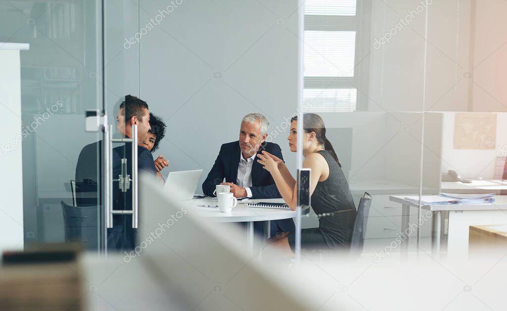 Planning their next venture. Shot of a group of businesspeople having a meeting together in an office.