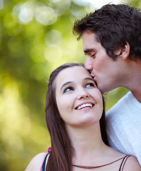 Jeune amour. Tournage de jeunes couples partageant un moment de tendresse dans le parc. — Photo