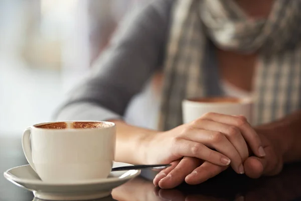 Enjoying a coffee shop date. Cropped shot of a couple sitting in a coffee shop. — Stock Photo, Image