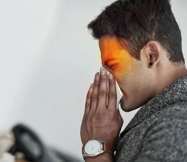 His sinuses are killing him. Cropped shot of a young man suffering with allergies. — Stock Photo, Image