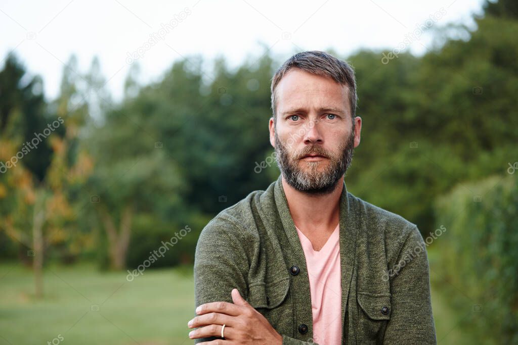 Its time to unwind. Portrait of a handsome mature man standing in a park.